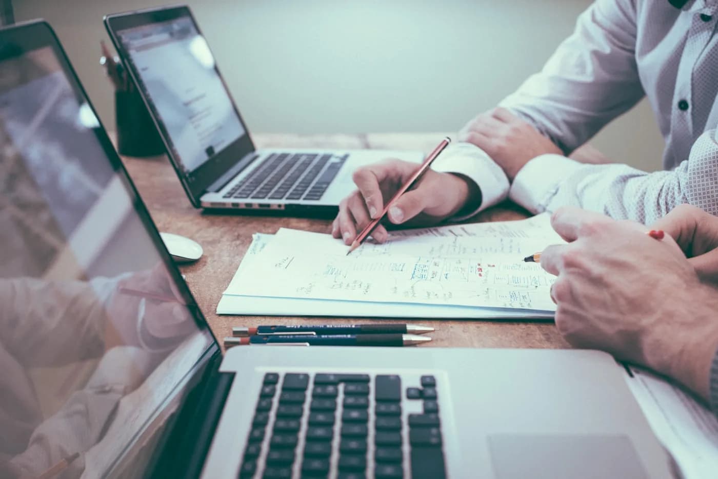 Business documents and notes spread across a desk during analysis